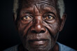 Close up portrait of old sad unhappy afro man looking at camera. Part of black unshaved male face.