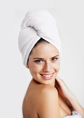 Poster - Happy, beauty and woman with towel in a studio for health, wellness and natural face routine. Smile, skincare and portrait of young female model with facial dermatology treatment by gray background.