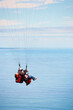 © Cameron M/peopleimages.com - Sky, ocean and air with a couple in a parachute together for travel, freedom or adventure. Sea, summer or nature with a man and woman flying over the water while bonding on holiday or vacation
