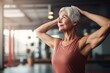 © Denis - Joyful Senior woman practicing yoga at gym healthy class