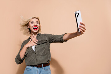 Sticker - Photo of impressed funky lady wear khaki shirt high speed modern device 4g connection isolated beige color background