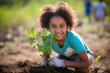 Happy little Latin American girl plants a tree. Green nature concept.