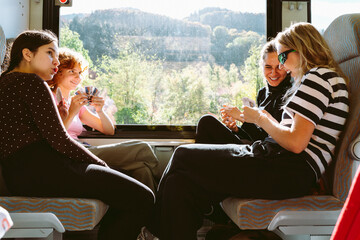 group teenage female students travels by train