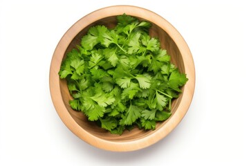 Wall Mural - Parsley in a white background, from above, in a wooden bowl.