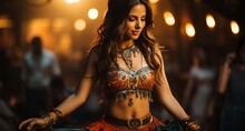 A Girl With A Beautiful Body Dances A Belly Dance In Oriental Attire With Jewelry And Pendants. Woman With Long Hair In Motion.