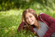 © Marine G/peopleimages.com - Portrait, grass and woman relax in field with smile, happy and park on summer weekend outdoors. Nature, countryside and person sitting in meadow for calm, peace and fresh air on holiday or vacation