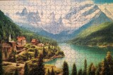 Fototapeta  - A puzzle with unfinished landscape, jigsaw, mountains, lake, leisure. Generative AI