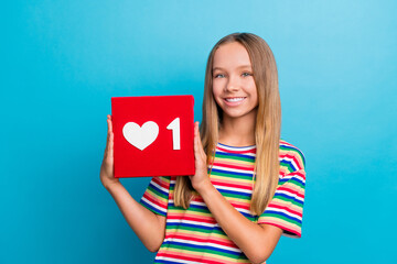 Poster - Photo of positive nice schoolgirl with straight hair dressed striped t-shirt hold social media like isolated on blue color background