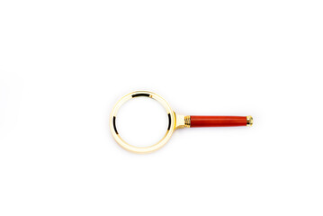 Wall Mural - Magnifying glass. Magnifying glass with gold-plated handle. On a white background.