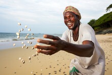 African Sorcerer Using Cowrie Shells For Divination