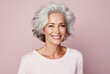 Portrait of attractive elderly happy laughing woman with gray hair over pink background. AI generated