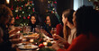 © Gianluca Lubrano - Friends of various ethnicities enjoying a joyful Christmas dinner together at home