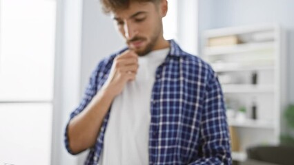 Poster - Worried yet focused young arab man working hard in his office, a diligent worker engrossed in reading important business documents, in an elegant indoor setting, amid a professional background.