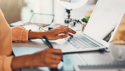 Graphic designer, blogger and young entrepreneur working on a laptop while designing a logo or website while drawing with a digital stylus pen. Hands of a creative woman using modern digital tools