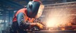 © ETAJOE - Metal welder working with arc welding at wokshop, Industrial worker is welding steel products in a factory, sparks fly