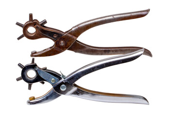 Wall Mural - Tailor accessories. Close-up of a antique adjustable steel punch pliers and a modern hole punch tool isolated. Clipping path. Tools from tailor, saddler or cobbler.