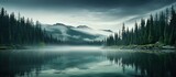 Fototapeta Natura - Misty serene forest by an emerald lake in Canada