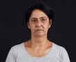 © David Lahoud/peopleimages.com - Senior woman, portrait and mental health, depression and crisis with abuse isolated on black background. Sad, angry and anxiety with depressed female person, serious face and grief in a studio