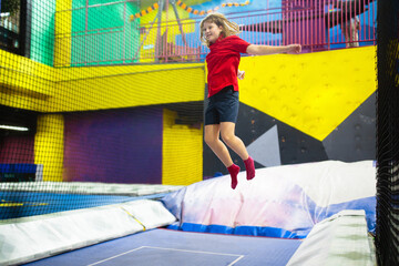 Wall Mural - Child jumping in trampoline park. Bounce fun.