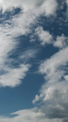 Wall Mural - Vertical quality time lapse of a clouds and blue sky. No birds, no flicker.