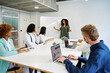 © alvaro - Woman explaining a project to colleagues in a coworking