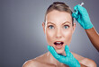 © C. Daniels/peopleimages.com - Needle, scared woman and portrait for skincare, collagen or beauty process in studio. Cosmetics, surprise face and injection of plastic surgery, botox facial change or aesthetic prp implant on mockup