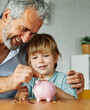 © Lumos sp - child money saving grandfather family coin senior finance bank piggybank happy investment grandson boy financial elderly cash