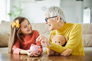 child money saving grandfmother family coin senior finance bank piggybank happy investment granddaughter girl financial elderly cash