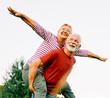 © Lumos sp - woman man outdoor senior couple happy lifestyle retirement together smiling love piggyback active mature