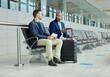 Ticket, airport and business partner or people talking of flight schedule, travel news or schedule update together. Conversation, waiting room and international or professional person with suitcase