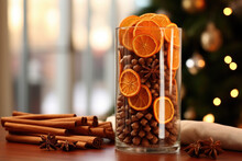 A Simple And Elegant Arrangement Of Dried Orange Slices, Cinnamon Sticks, And Anise Stars Nestled In A Tall Glass Vase.