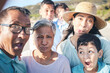 © Azeemud/peopleimages.com - Selfie, funny and portrait with family on vacation for bonding with children in summer in outdoor. Face, love and silly with kids or parents and senior people on holiday for quality time on beach.