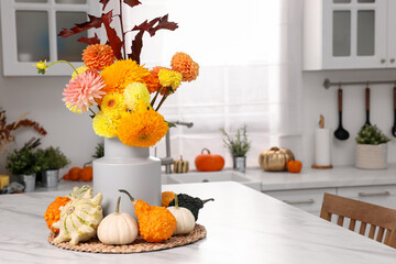 Sticker - Beautiful autumn bouquet and pumpkins on marble table in kitchen