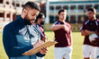 © Anela/peopleimages.com - Fitness, rugby and coach with clipboard, teamwork and training for competition, workout and wellness. Male, trainer and group with healthy lifestyle, sports and practice for exercise, support or plan