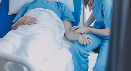 Injured patient showing doctor broken wrist and arm with bandage in hospital office or emergency room. Sprain, stress fracture or repetitive strain injury in hand. Nurse helping customer. First aid.