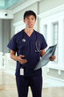 © Image Smith - Asian Male nurse holding an X-ray.