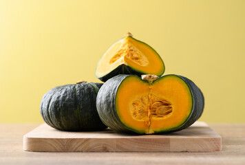 Canvas Print - Green pumpkin or Japanese pumpkin on yellow background, Vegetable in autumn season