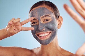 Poster - Woman, face mask and selfie in charcoal skincare and facial profile picture on studio blue background. Photography, peace and v sign of beauty influencer or person portrait, collagen and dermatology