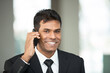 © Image Smith - Indian business man using mobile phone.