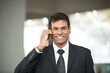© Image Smith - Indian business man using mobile phone.