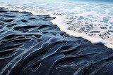 Fototapeta Konie - Crystal Dunes: Captivating Wave Patterns on Black Sand Beach