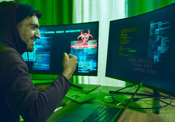 Fototapete - Cybersecurity, crime and happy man programming in neon office with code, fraud and hacking with hoodie. Software, ransomware and hacker on cyber attack, password thief coding online scam and success.