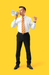 Canvas Print - Handsome steward with wooden airplane shouting into megaphone on yellow background