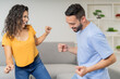 © Guillermo Spelucin - Latin couple dancing together happily at home