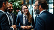 © seesulaijular - A group of businessmen, men and women, chatted excitedly in office clothes in a conference room.