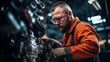 a worker in an orange jumpsuit, working on a machine in a factory. The worker is using a wrench and is surrounded by machinery.close up