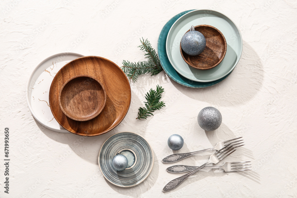 Beautiful table setting with Christmas balls and fir branches on white background
