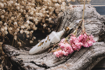 Wall Mural - Perfume bottle and dried flowers close up background.