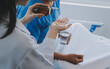 © Sirikarn Rinruesee - Injured patient showing doctor broken wrist and arm with bandage in hospital office or emergency room. Sprain, stress fracture or repetitive strain injury in hand. Nurse helping customer. First aid.
