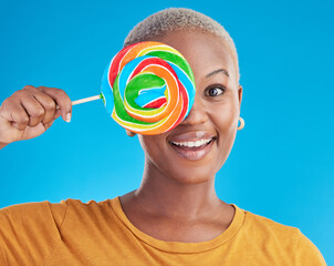 Wall Mural - Portrait, cover and black woman with a lollipop, candy and happiness on a blue studio background. Face, happy female person and African model with sugar treats, confectionary and cheerful girl
